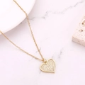 Macro shot of gold heart pendant encrusted with white cubic zirconia on a marble surface - Style 9 (N1059)