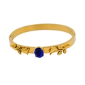 Polished 18k gold stainless steel bangle with blue oval gemstone and rose carving - Ink Blue Zirconia