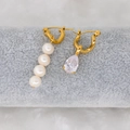 Detail view of asymmetric gold earrings with white pearls and drop-cut zircon gemstone - White