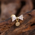 Macro view of gold bow earring with triangle zircons and pavé round charm detail - Triangle Zirconia Bow Pendant Style (3138) / Gold
