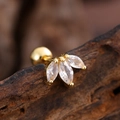 Macro shot of gold stainless steel marquise zircon stud earrings on wood texture - Three Marquise Leaf Style (3140) / Gold