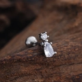 Macro detail of silver barbell earring with round and pear-shaped cubic zirconia studs - Pear Double Zircon Style (3437) / Silver
