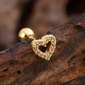 Macro detail of a heart-shaped gold earring with cubic zirconia on a rustic wood surface - Hollow Heart Pave Style (3144) / Gold