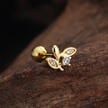 Macro shot of gold flower cartilage stud with cubic zirconia and screw ball back on wood - Leaf Shape (3440) / Gold