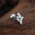 Macro shot of a silver floral ear stud with marquise and round cubic zirconia on wood - Marquise Petal Flower (3441) / Silver