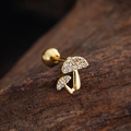 Detailed macro view of golden double mushroom ear studs with zircon on wooden surface - Mushroom Shape (3442) / Gold