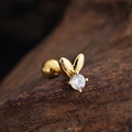 Detailed macro view of a golden rabbit ear stud with a sparkling round zircon and ball back - Rabbit Design (3454) / Gold