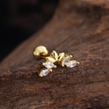 Macro shot of gold labret stud with marquise-cut zircons in leaf wing design on wood - Curved Fan Style (3455) / Gold