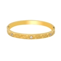 Detail of 18K gold-plated bangle with engraved S-scroll patterns and inset zircons - Bangle