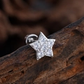 Silver star cartilage stud earring with micro-pave zircons on a dark wood background - Star Style (3380) / Silver