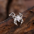 Silver spider earring with marquise-cut zircon on dark wood background - Marquise Zirconia Spider Style (3137) / Silver