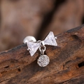 Silver bow stud earring with sparkling cubic zirconia on a rustic wood background - Triangle Zirconia Bow Pendant Style (3138) / Silver