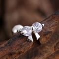 Silver bow stud earring with sparkling zircon and metal tassel detail on wood background - Double Zirconia Bow Pendant Style (3134) / Silver