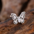 Silver butterfly cartilage stud earring with cubic zirconia on a natural wood surface - Trapezoid Marquise Butterfly Style (3132) / Silver