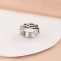 Detailed macro shot of silver industrial gear ring on a white round display stand - Size 6 / Multi-layer Chain Gear Style (CK1498) / Steel