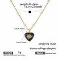 Detailed view of black enamel heart pendant on a 41+6cm golden stainless steel bead chain - Heart Daisy Style (DKN25-372GL)