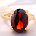 Elegant gold crown ring with a large oval red zircon in a four-prong setting - US 7