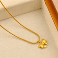 Macro shot of gold bow pendant with textured engraving and fine snake bone chain - Bowknot Snake Chain Style(CK798) / Gold