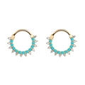 Macro shot of gold-plated hoop with turquoise beads and sparkling cubic zirconia stones - Blue Turquoise Gold