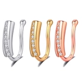 Close-up of three U-shaped nose clips in silver, gold, and rose gold with zircon stones - Gold