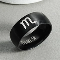 Macro shot of black titanium ring featuring Scorpio zodiac sign and inner engraving - Scorpio