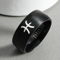 Macro shot of black titanium steel Pisces zodiac ring with matte finish and engraving - Pisces