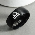 Detailed macro view of black matte titanium ring featuring engraved Libra zodiac symbol - Libra