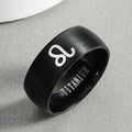 Detail of black titanium ring featuring silver Leo zodiac symbol and brushed metal finish - Leo