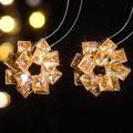 Macro shot of gold flower earrings with yellow square-cut zircons and beaded edge detail - Gold and Champagne Vintage Style