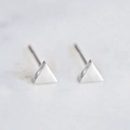 Polished silver stainless steel geometric triangle stud earrings for women on marble - Steel