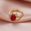 Detailed macro view of gold deer antler ring with large red oval stone on pink silk - Red Cabochon Antler Style (ALR011GLR) / Gold