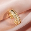 Retro twisted gold ring with textured weave pattern on elegant pink silk background - Adjustable Open / Gold Twisted Style (ALR064GL)