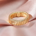Macro view of a gold-plated Tubogas style textured ring on a premium silk background - Adjustable Open / Gold Pleated Style (JZ630GL07)