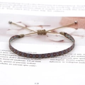 Detailed view of handmade bohemian woven bracelet with adjustable cord and geometric pattern - Purple Red Blue Brown Geometric (KZ-0014M)