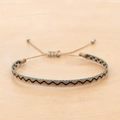 Detail of bohemian hand-woven bracelet with teal wave pattern and adjustable silver beads - Blue Black Gold Wave (KZ-0014S)