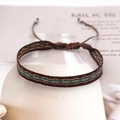 Detail of bohemian woven bracelet with blue and gold geometric patterns and adjustable cord - Dark Brown Blue Yellow Rhombus (KZ-0009A)
