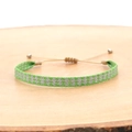 Close-up of handmade woven bohemian bracelet with green and silver geometric patterns - Green Silver Geometric (KZ-0012C)