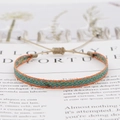 Macro shot of Bohemian woven friendship bracelet with ethnic patterns and sliding knot - Orange Blue Yellow Ethnic (KZ-0012H)