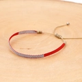 Macro detail of hand-woven bohemian bracelet with red thread and metallic accents - Red Silver Spliced Style (KZ-0038)