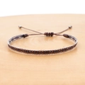 Close-up of bohemian hand-woven ethnic bracelet with adjustable brown cord and beads - Brown White Blue Geometric Style (KZ-0039)