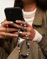 Close-up of beaded phone charm with black rabbits and crystal beads on a mobile case - Black Beaded Rabbit Style (SJ-A220002A)