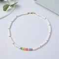 Bohemian white heishi clay bead necklace with rainbow accents and 18K gold-plated links - White and Rainbow Polymer Clay Bead Necklace (JS-N211001C)