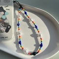Colorful beaded phone strap with white faux pearls and blue evil eye charms on a tray - Rainbow Seed Bead Evil Eye Imitation Pearl Style (SZ-A220011A)