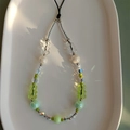Macro view of crystal beaded phone strap featuring green gummy bears and iridescent beads - Fruit Green Bear Style (SJ-A220017C)