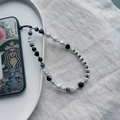 Fashionable black heart and white pearl beaded phone wrist strap on a ceramic tray - Black Heart Style (SZ-A230016A)