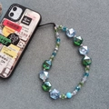 Close-up of colorful iridescent faceted beads on a green and blue crystal phone strap - Sj-a230010b