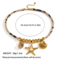 Detail view of ocean-themed necklace with gold starfish, seashell, and rope chain - Spiral Conch Starfish Scallop Triple Style (DKN254026GL)