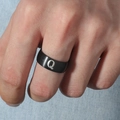 Primer plano de un anillo de acero inoxidable negro mate con diseño de letra Q plateada - Talla 6 / Estilo Letra Q (M566-Q) / Negro