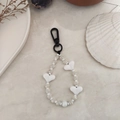 Detail shot of black and white striped acrylic beads with heart charm on marble surface - Gray and White Striped White Heart Beaded Style (YS-A230012F)