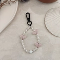 Detail of beaded heart keychain with pink acrylic hearts and black spring clasp hook - Beige Striped Pink Heart Beaded Style (YS-A230012J)